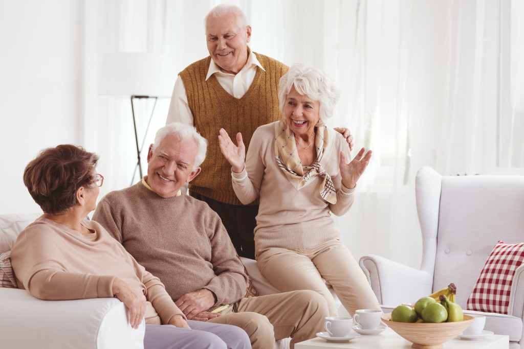 seniors sitting together on a sofa at a home